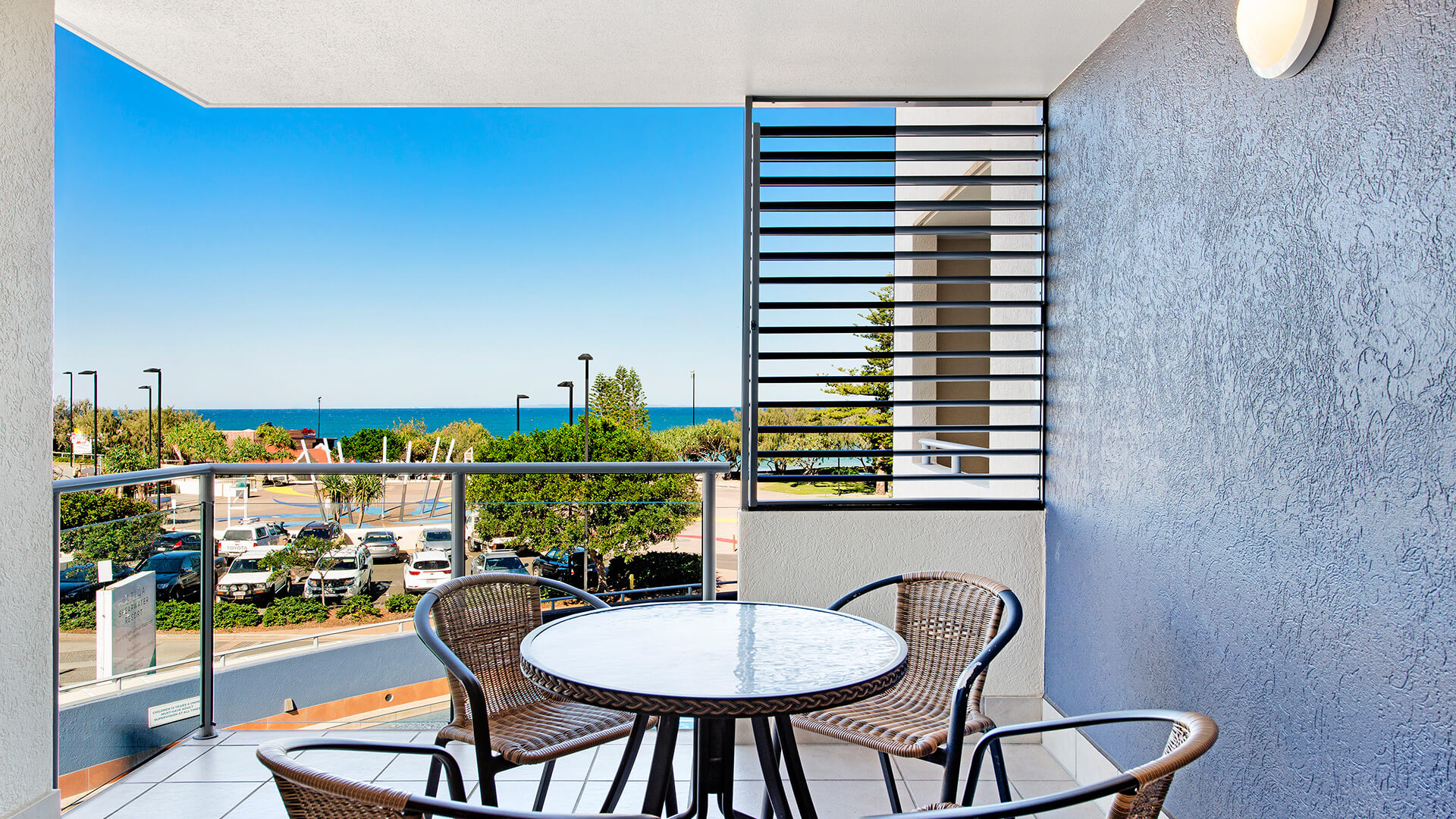 Private balcony with outdoor seating and ocean views in 2 Bedroom Apartment at ULTIQA Shearwater Resort.