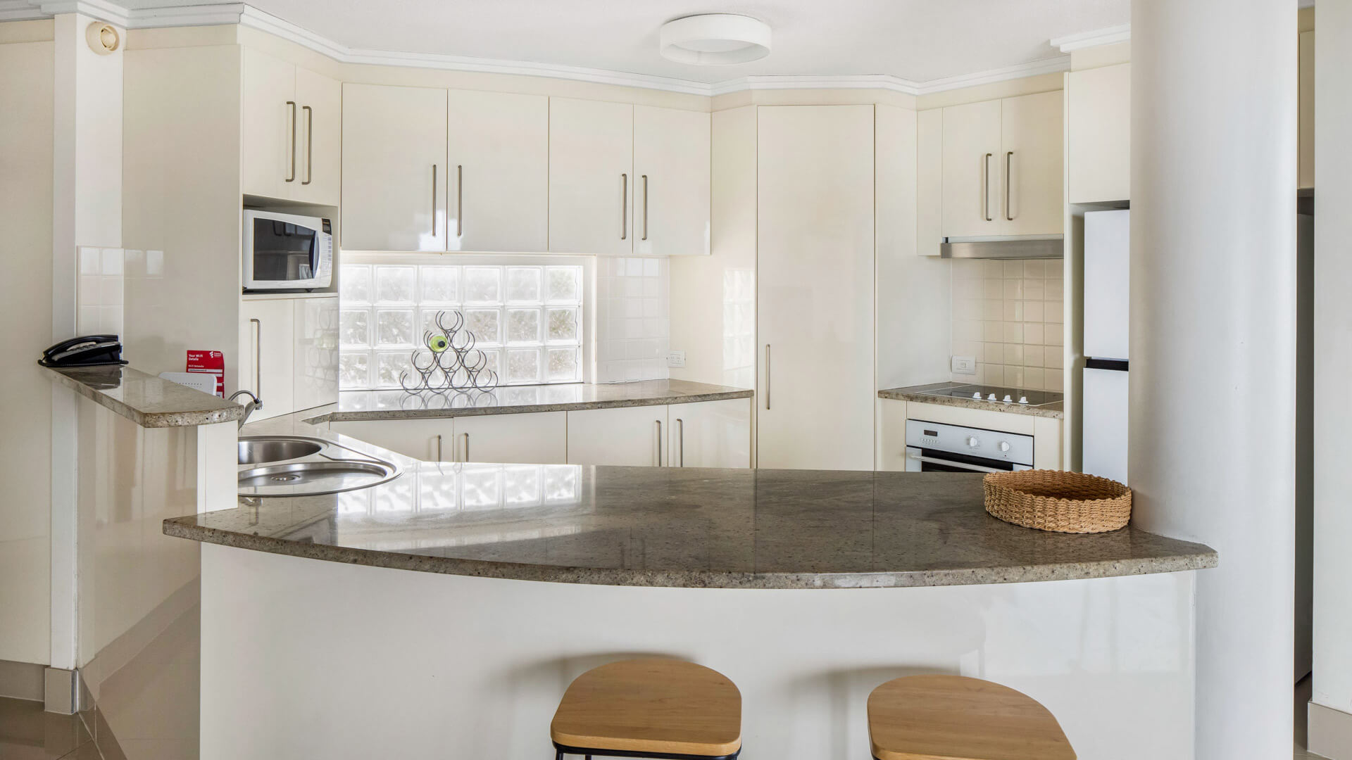 Modern kitchen with breakfast bar in 3 Bedroom Penthouse at ULTIQA Shearwater Resort.