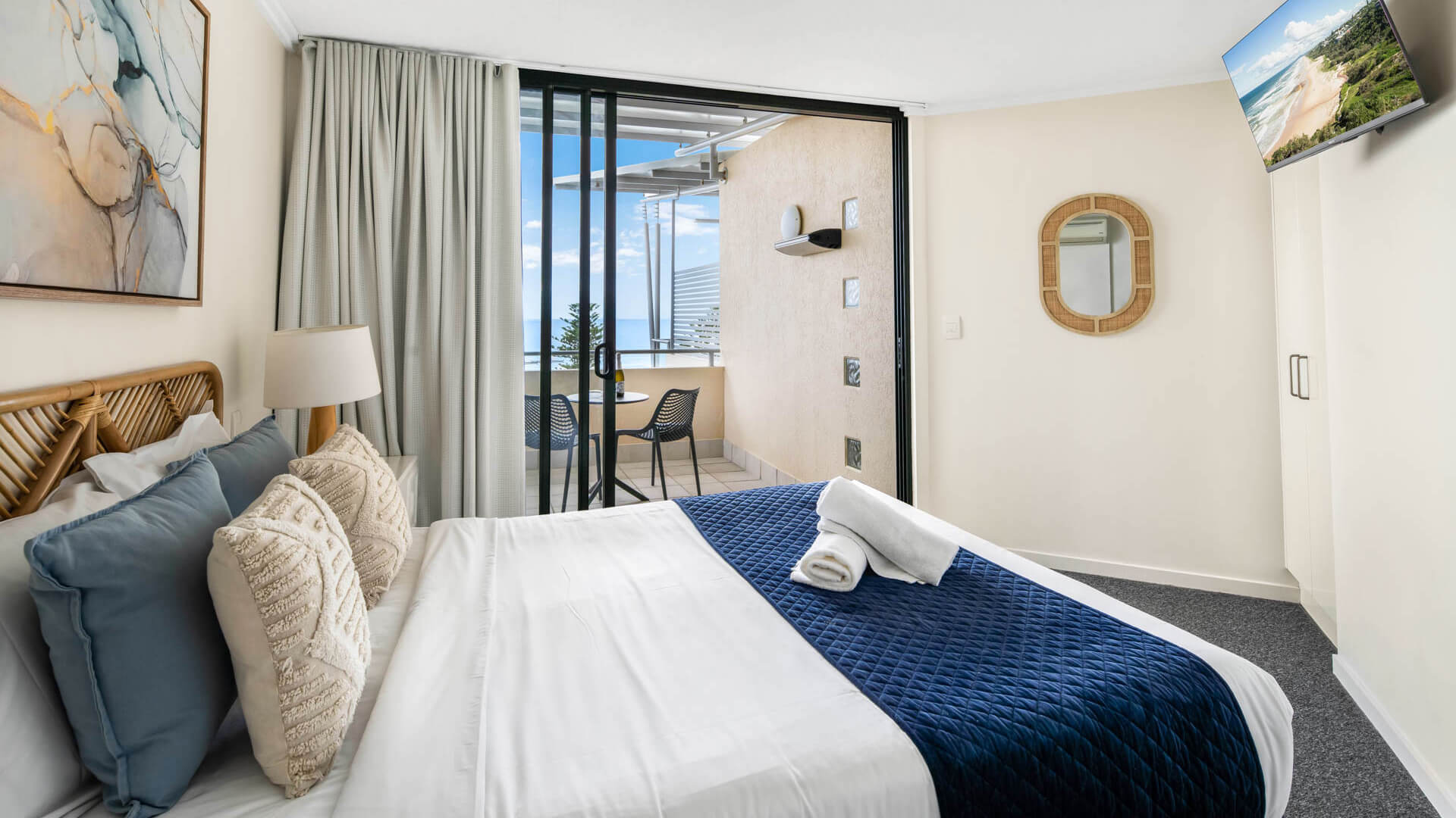 Ocean-view bedroom with balcony seating in 3 Bedroom Penthouse at ULTIQA Shearwater Resort.