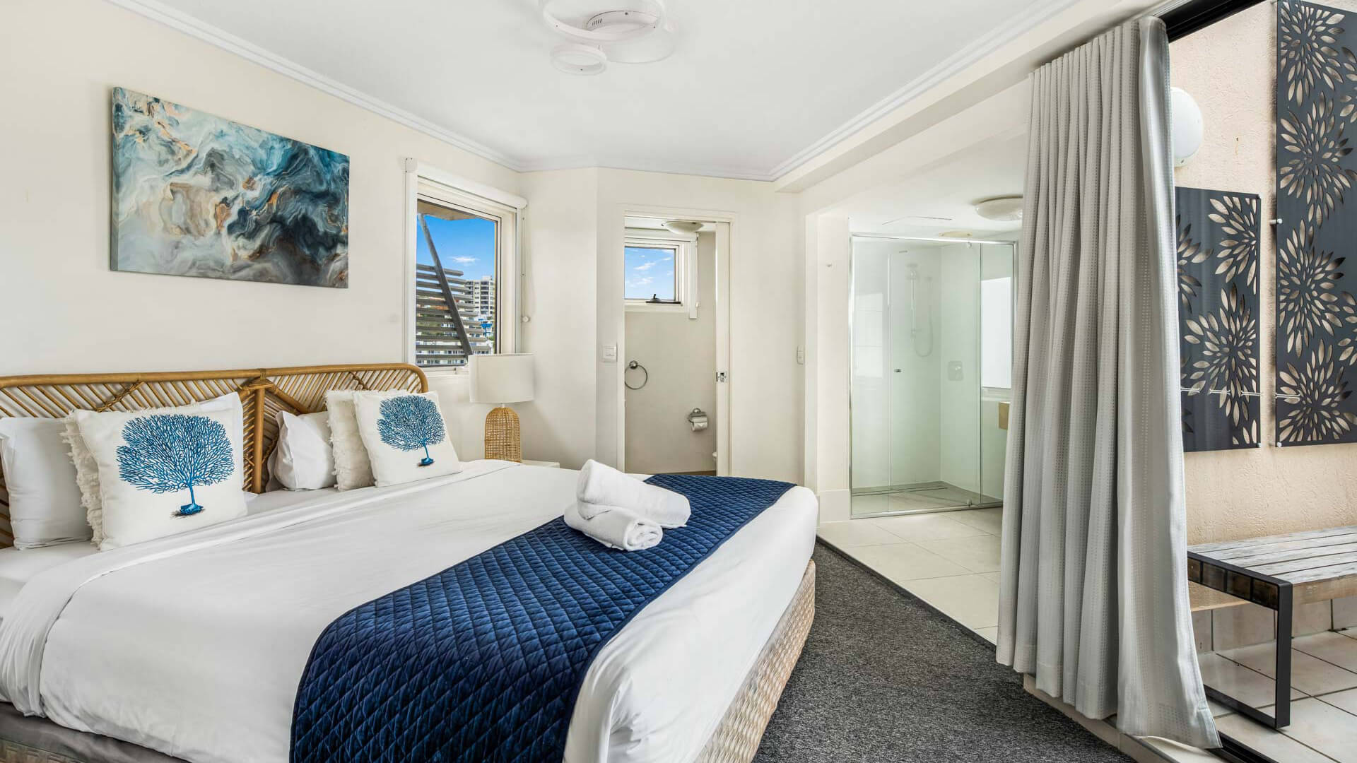 Bedroom with king bed, balcony access, and ensuite in 3 Bedroom Penthouse at ULTIQA Shearwater Resort.