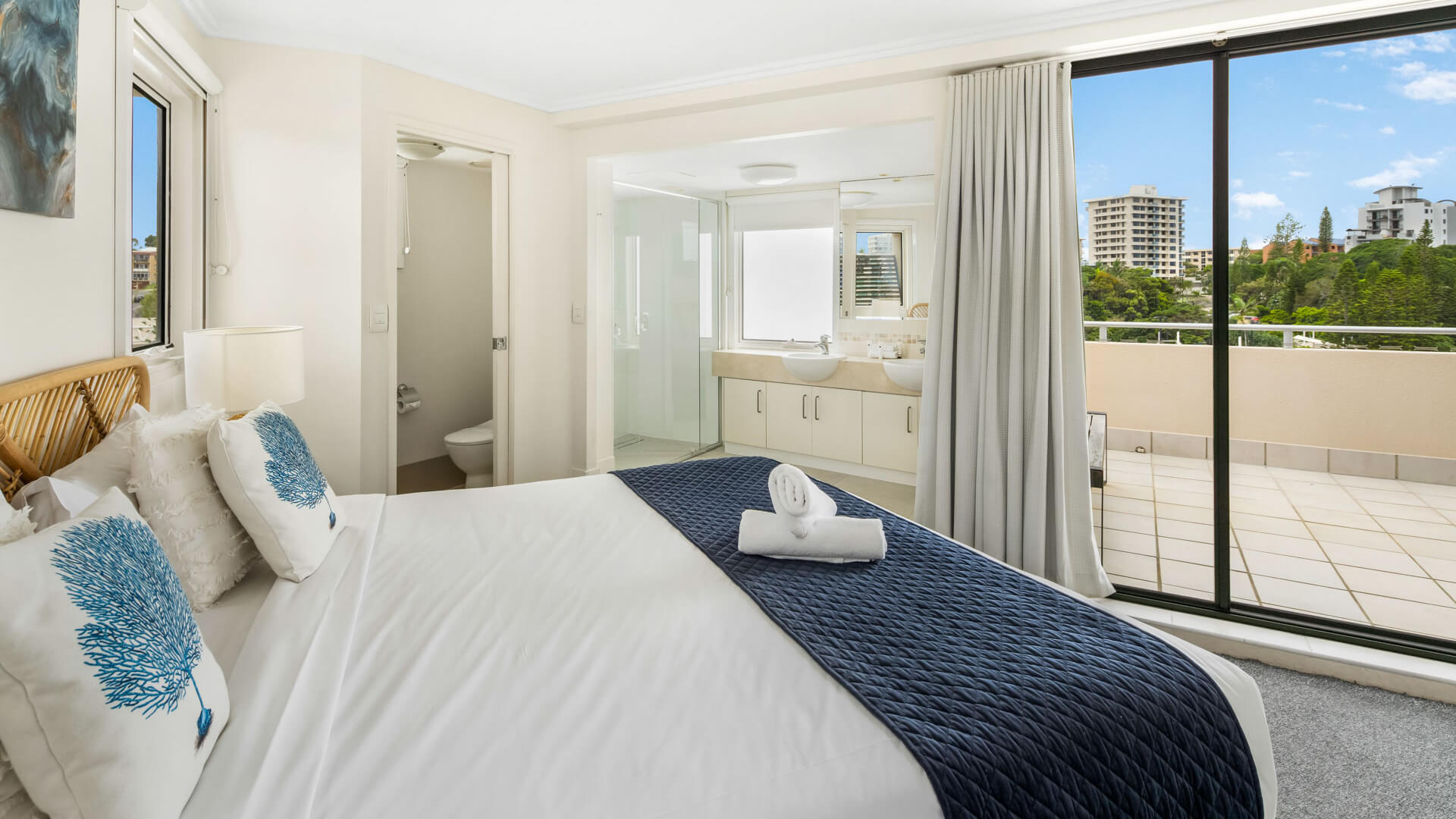 Bedroom with king bed, ensuite, and balcony access in 3 Bedroom Penthouse at ULTIQA Shearwater Resort.