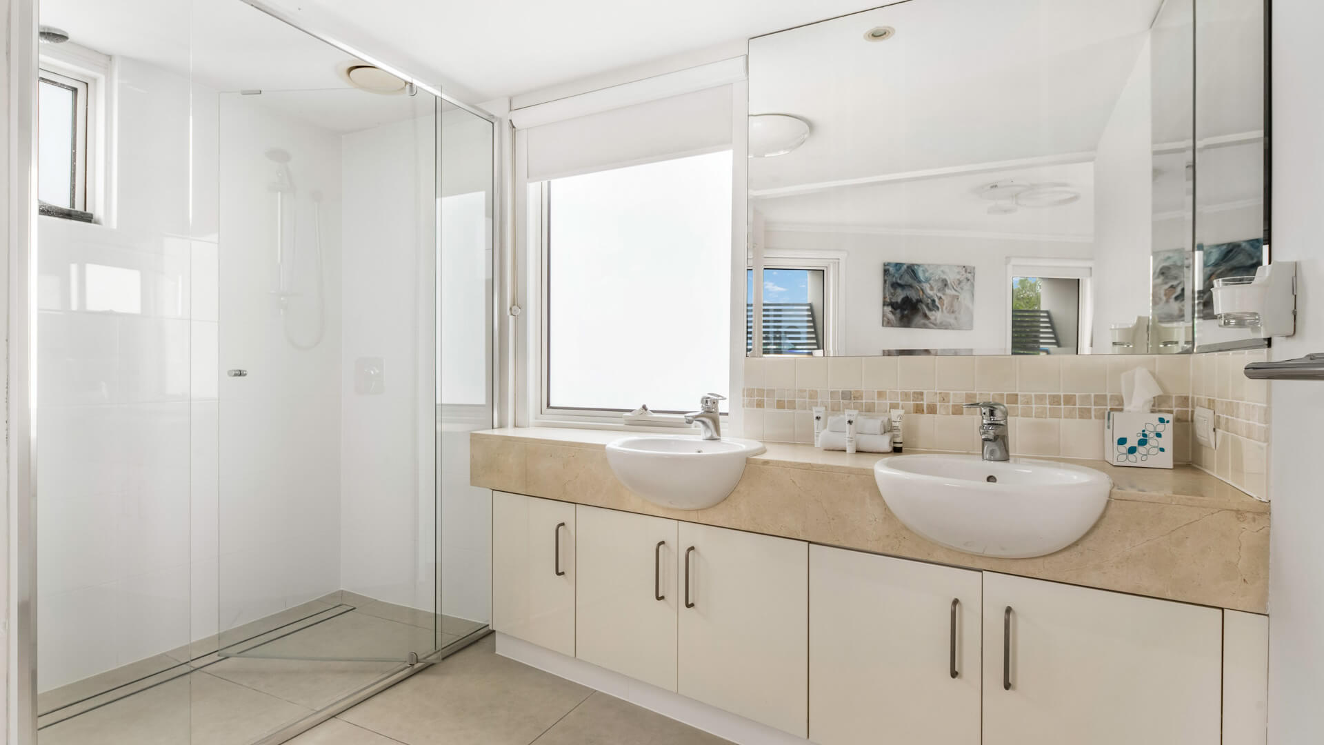 Modern bathroom with double vanity and walk-in shower in 3 Bedroom Penthouse at ULTIQA Shearwater Resort.