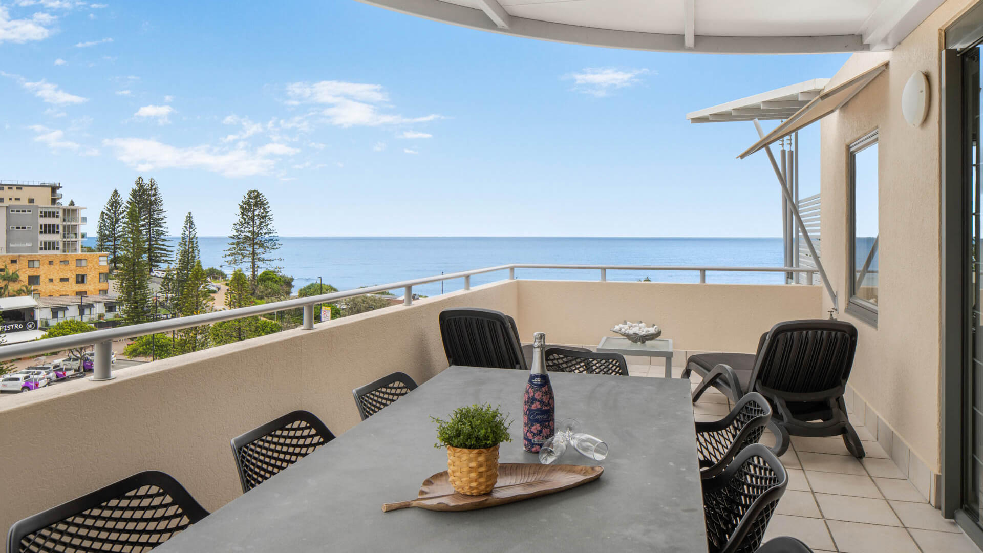 Spacious balcony with outdoor dining and ocean views in 3 Bedroom Penthouse at ULTIQA Shearwater Resort.