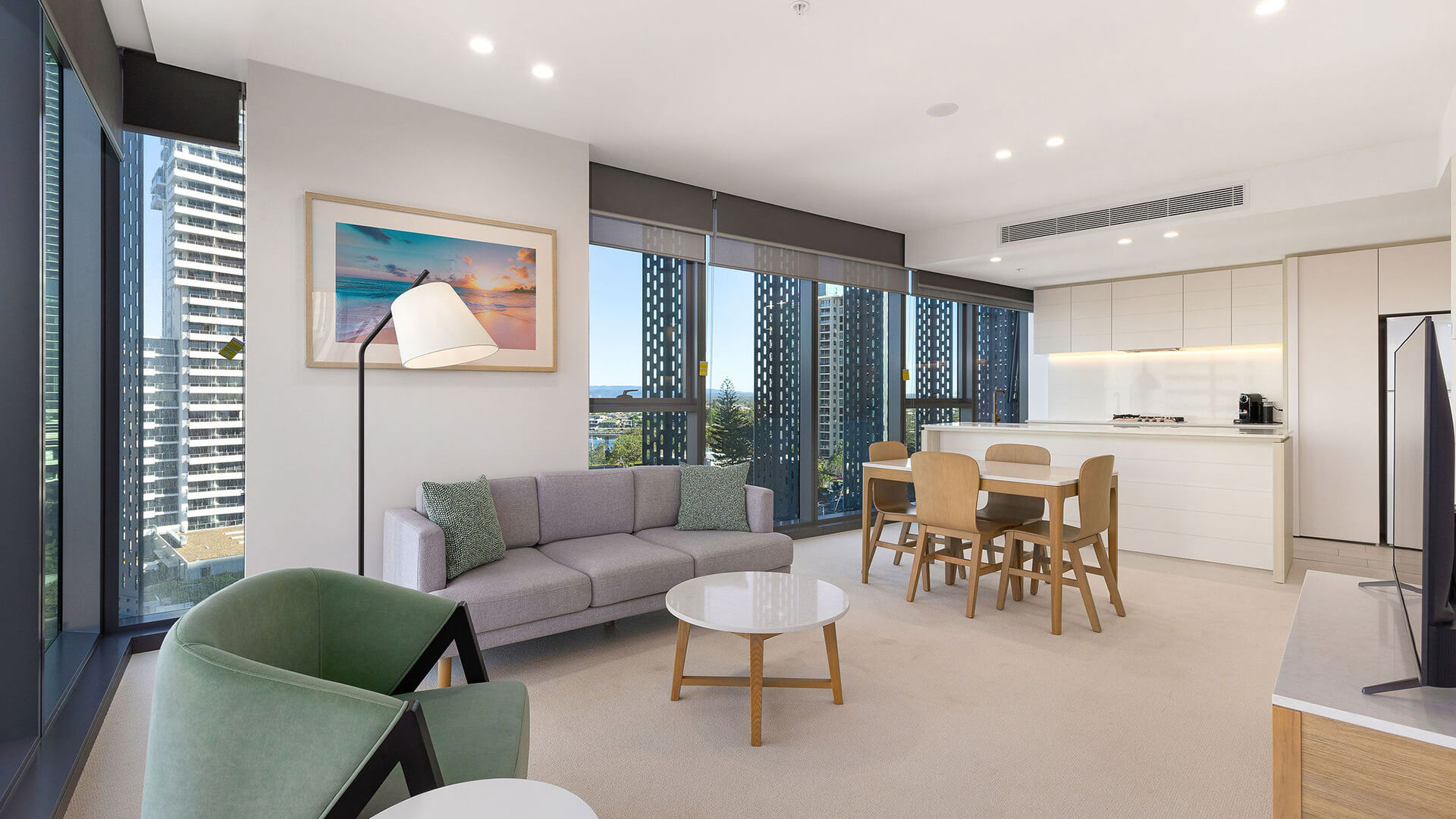 Modern open-plan living, dining, and kitchen area in the 1 Bedroom Suite at ULTIQA Signature at Broadbeach.
