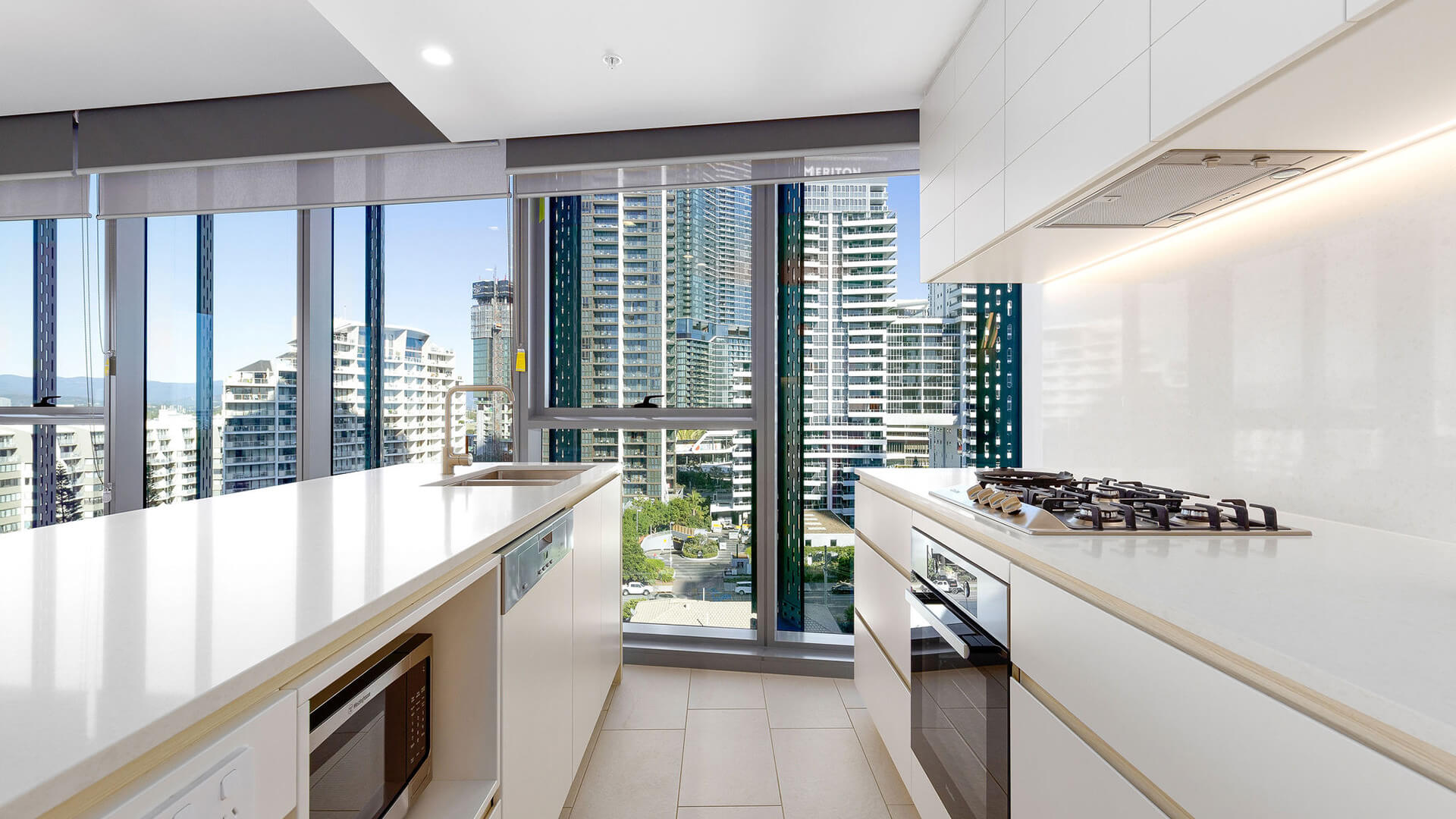 Fully equipped modern kitchen with city views in the 1 Bedroom Suite at ULTIQA Signature at Broadbeach.