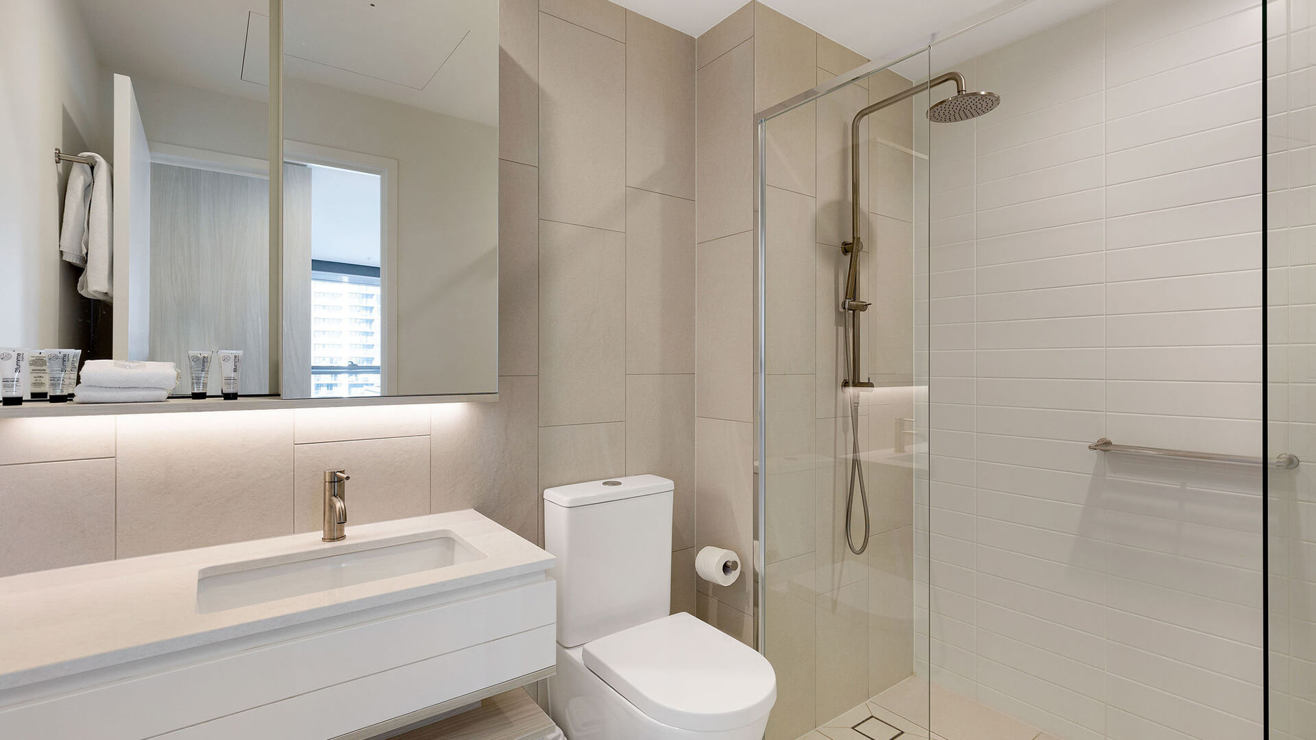 Modern bathroom with walk-in shower in the 1 Bedroom Suite at ULTIQA Signature at Broadbeach.