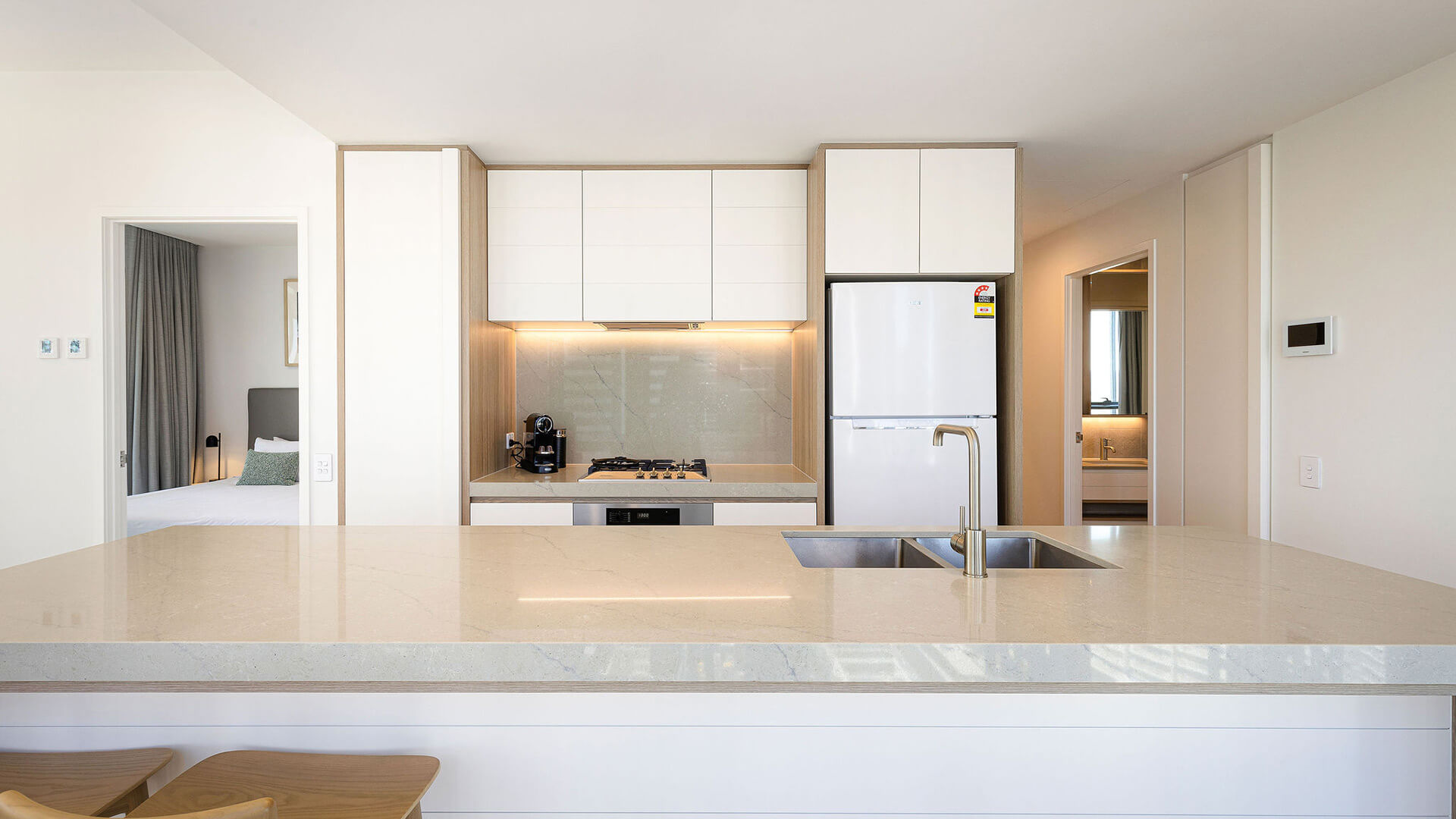 Kitchen in 2 Bedroom Suite at ULTIQA Signature at Broadbeach with island bench, modern appliances, and bedroom access.