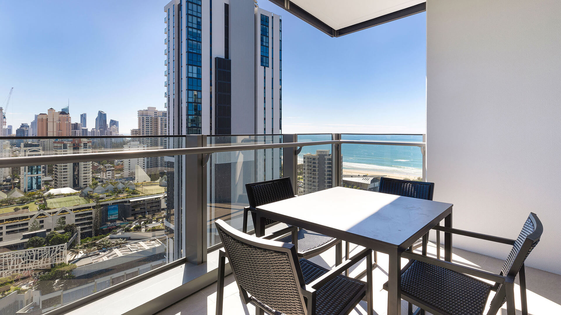 Balcony in 2 Bedroom Suite at ULTIQA Signature at Broadbeach with outdoor dining and ocean views.