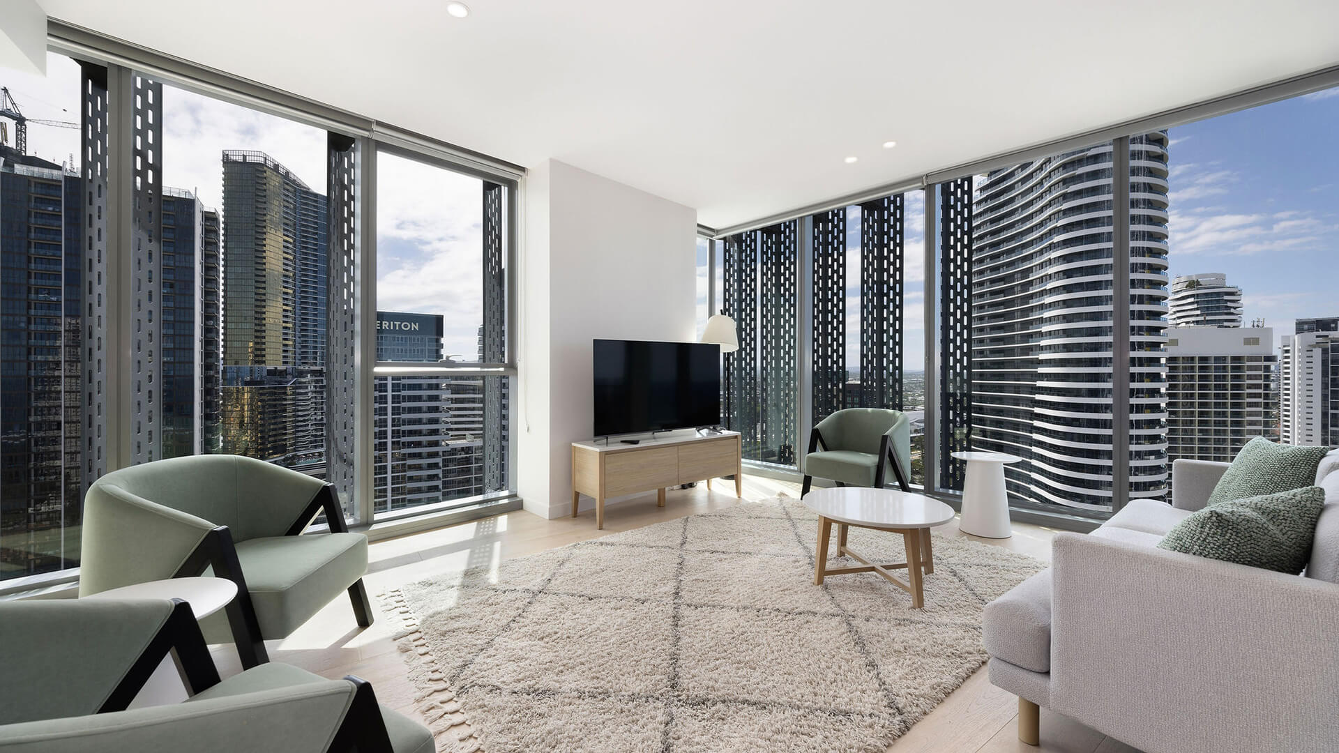 Spacious living area with city views in the 2 Bedroom Skyhome at ULTIQA Signature at Broadbeach.