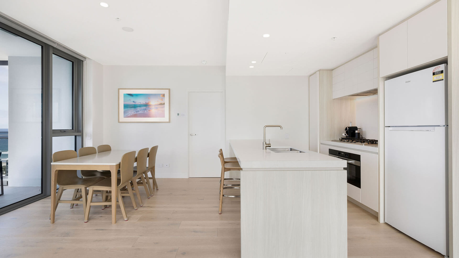Modern kitchen and dining area in the 2 Bedroom Skyhome at ULTIQA Signature at Broadbeach.