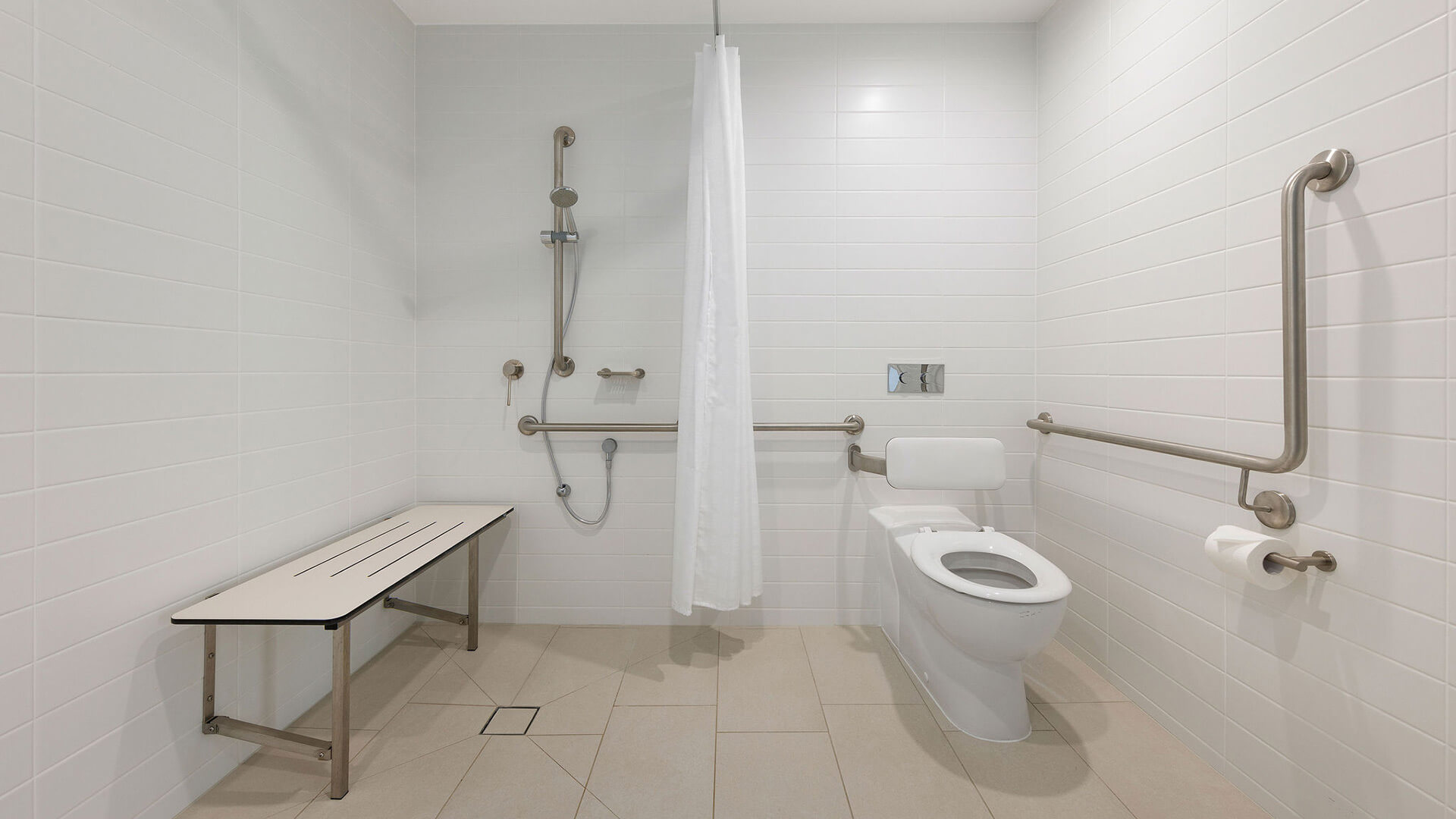 Accessible bathroom with shower bench in 2 Bedroom Accessible Suite at ULTIQA Signature at Broadbeach.