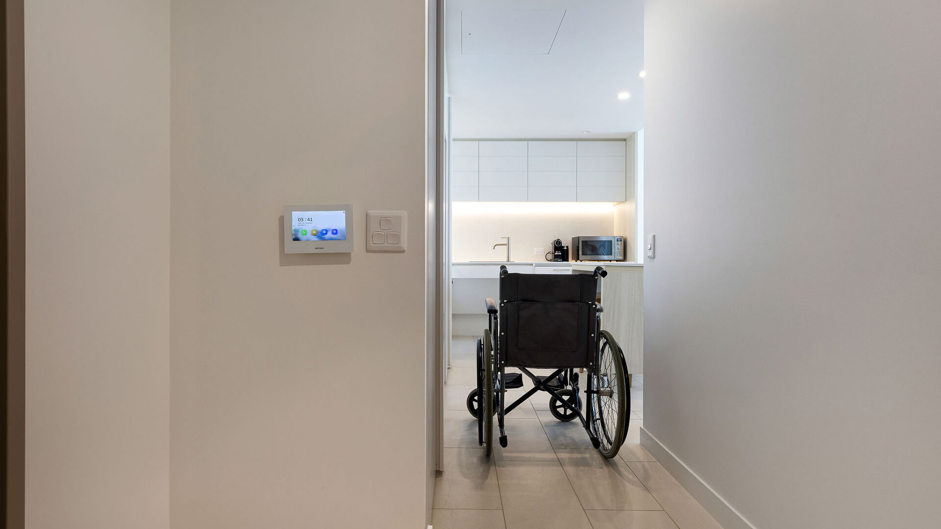 Wheelchair in hallway leading to kitchen in 2 Bedroom Accessible Suite at ULTIQA Signature at Broadbeach.