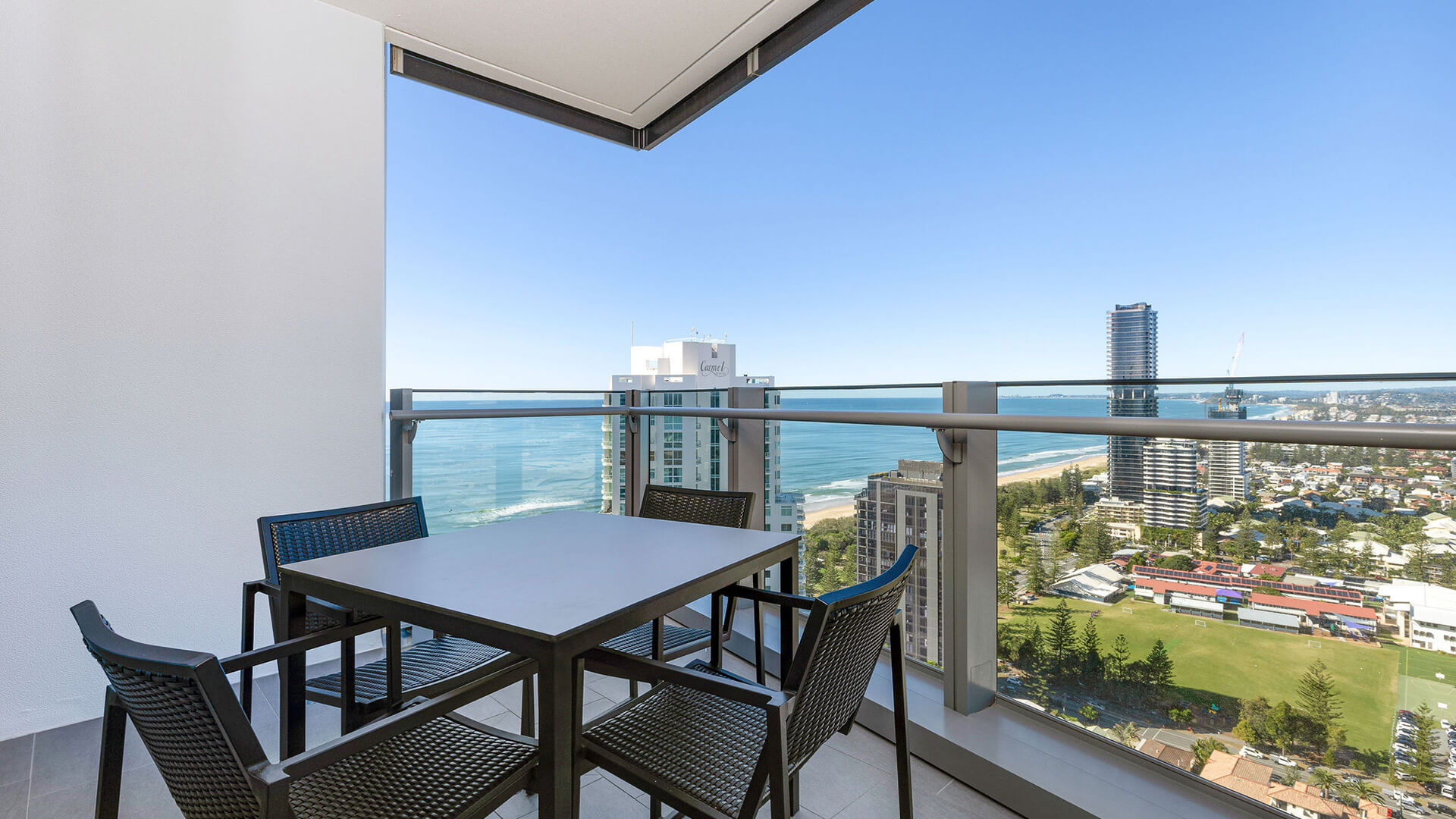 Private balcony with outdoor dining and sweeping ocean views in the 2 Bedroom Ocean View Suite at ULTIQA Signature at Broadbeach.