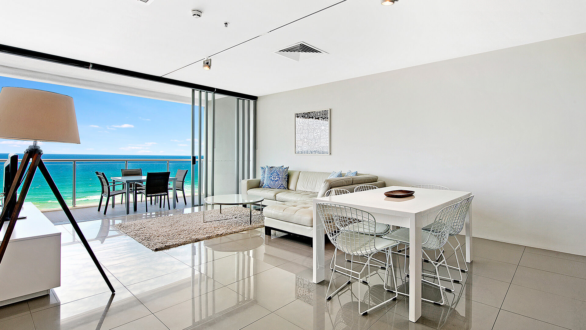 Dining and lounge area with balcony views in 1 Bedroom Ocean View Apartment at ULTIQA Air on Broadbeach.