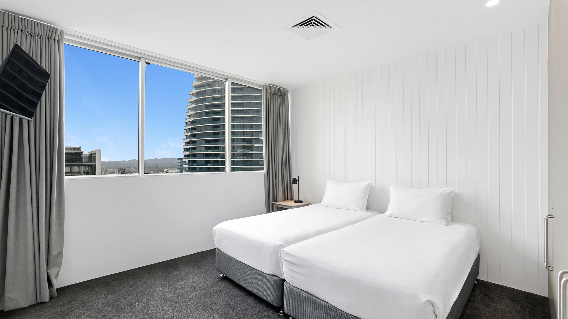 Second bedroom with twin beds and city views in 2 Bedroom Gold Coast View Suite at ULTIQA Air on Broadbeach.