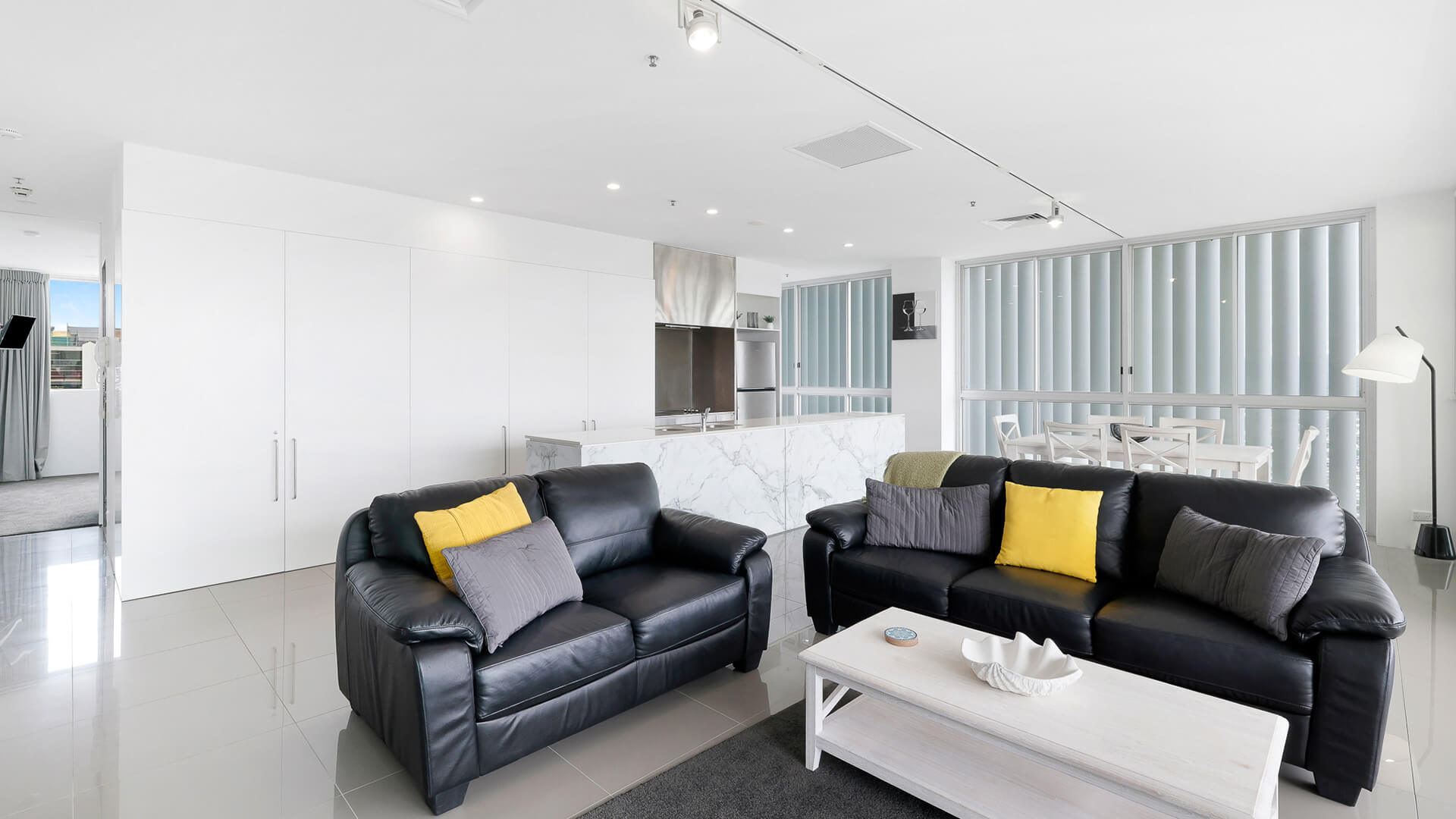 Contemporary lounge and kitchen area in 2 Bedroom Gold Coast View Suite at ULTIQA Air on Broadbeach.