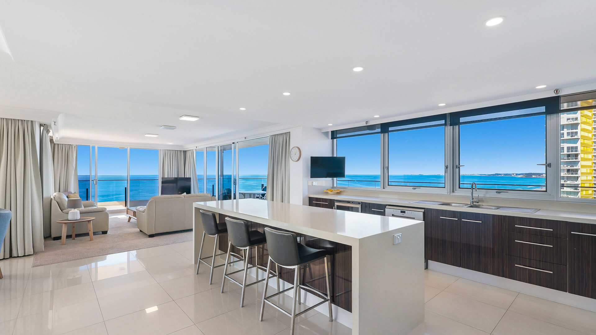 Open-plan kitchen and lounge with ocean views in the Sub Penthouse at ULTIQA Beach Haven.
