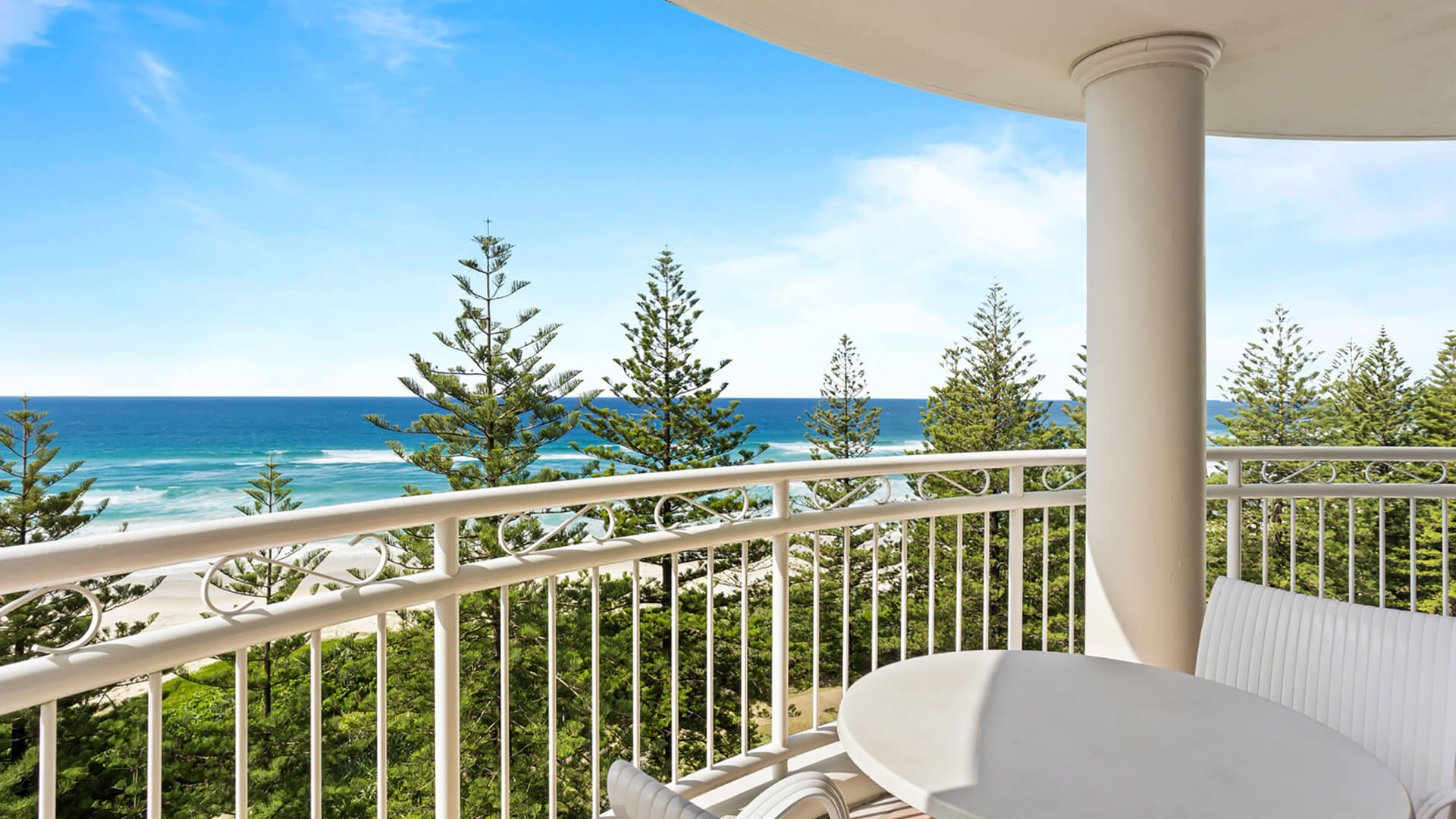 Private balcony with outdoor seating and ocean views.