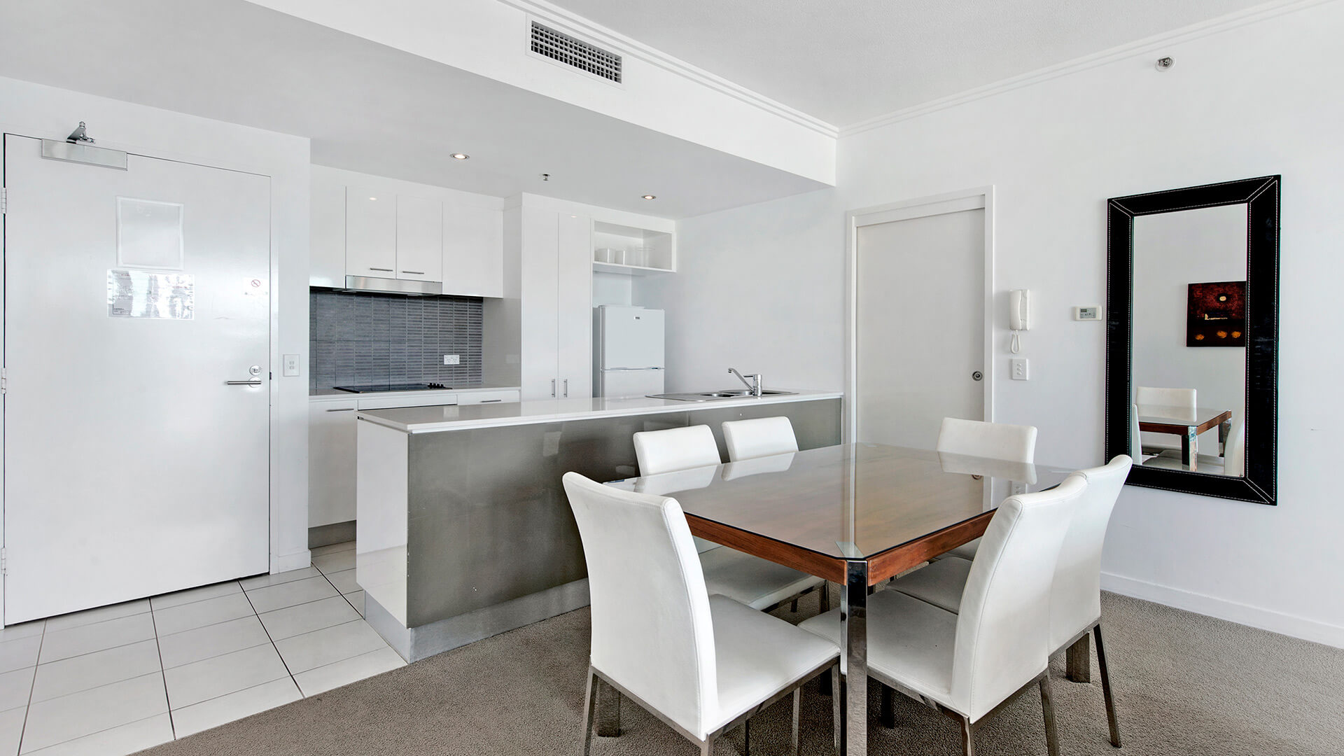 Fully equipped kitchen and dining area in the 1 Bedroom Apartment at ULTIQA Freshwater Point Resort.