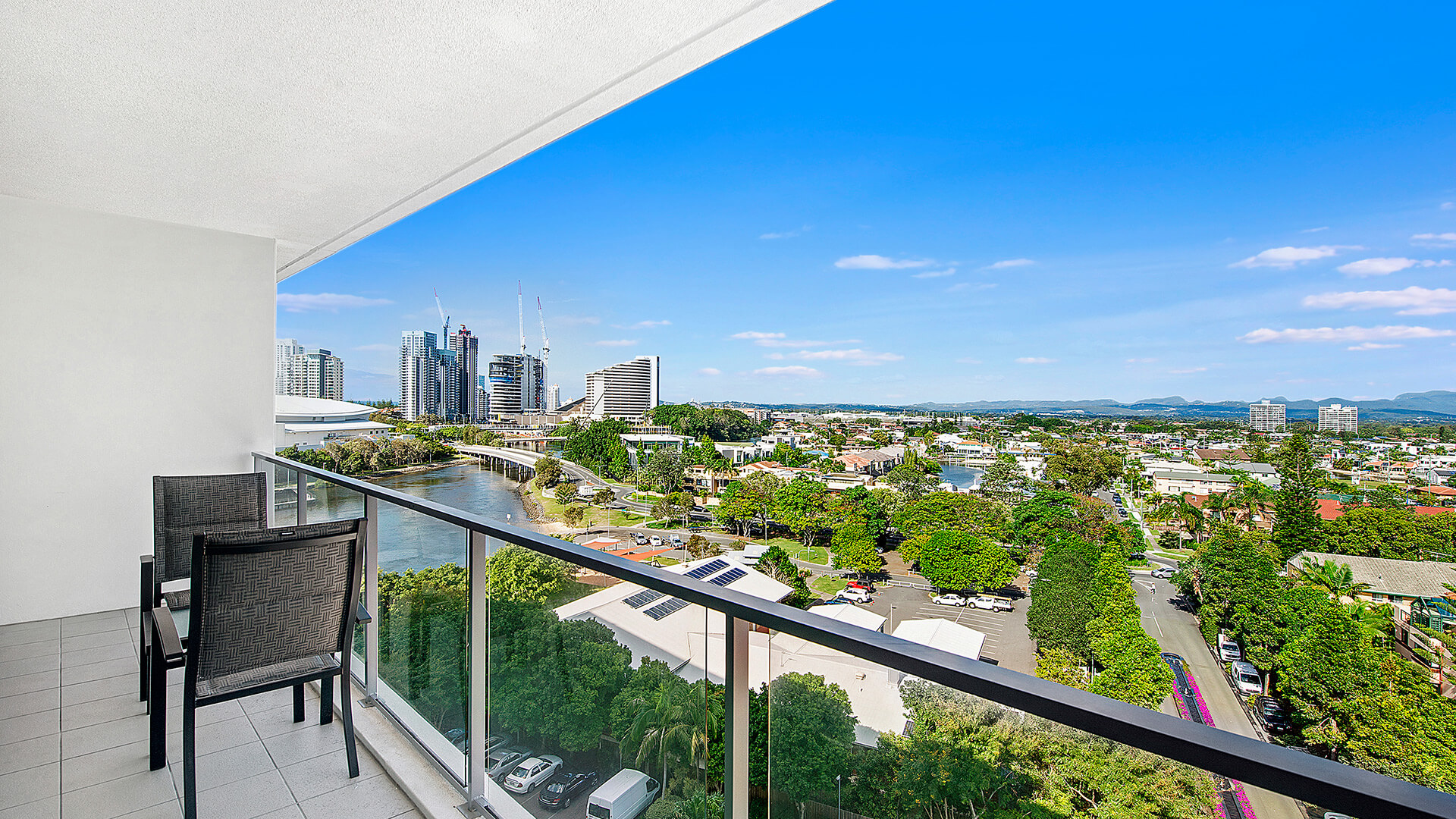 Private balcony with seating and city views from the 3 Bedroom Apartment at ULTIQA Freshwater Point Resort.