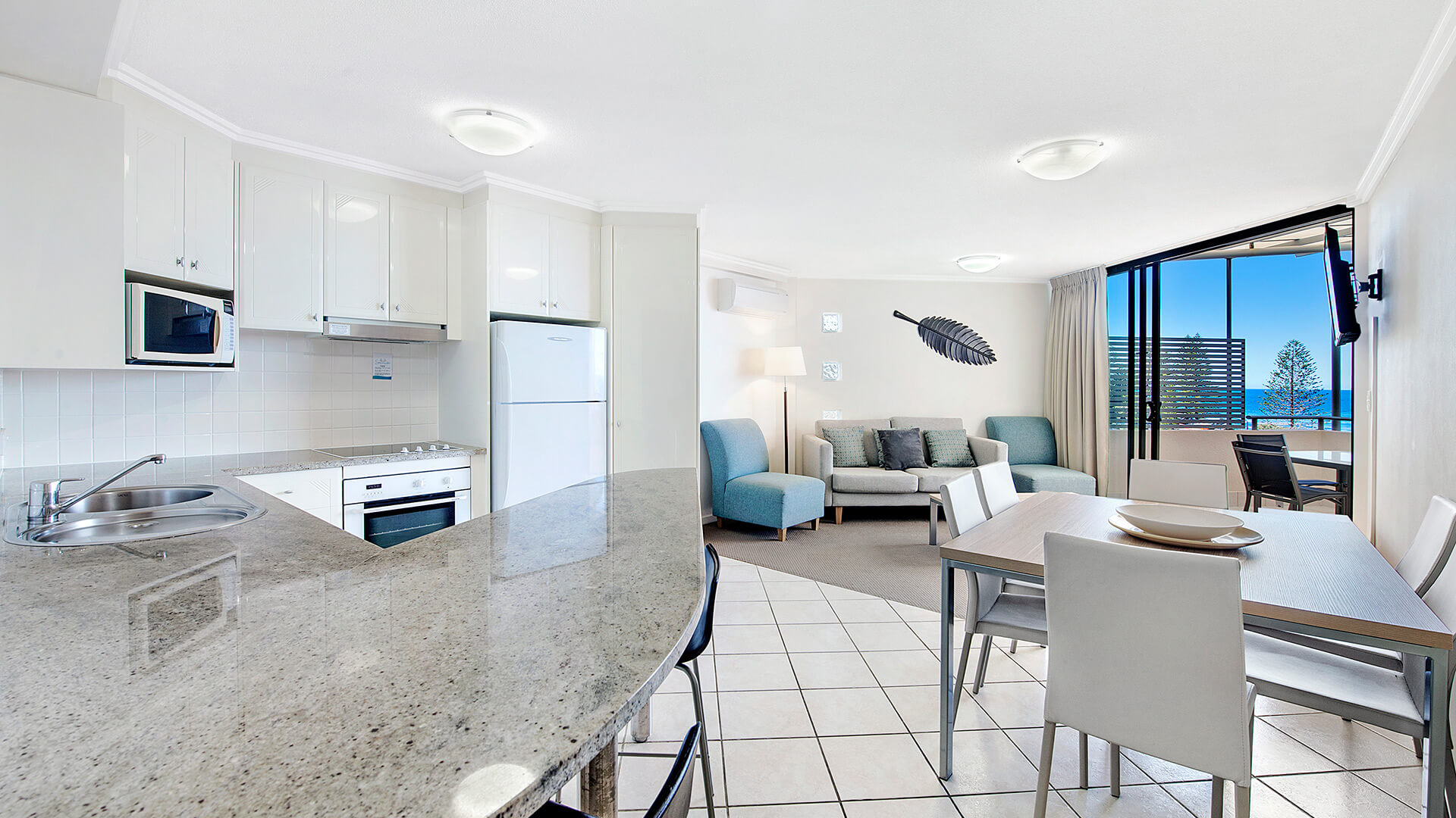 Kitchen and dining area with ocean-view living space in 2 Bedroom 1 Bathroom Apartment at ULTIQA Shearwater Resort.
