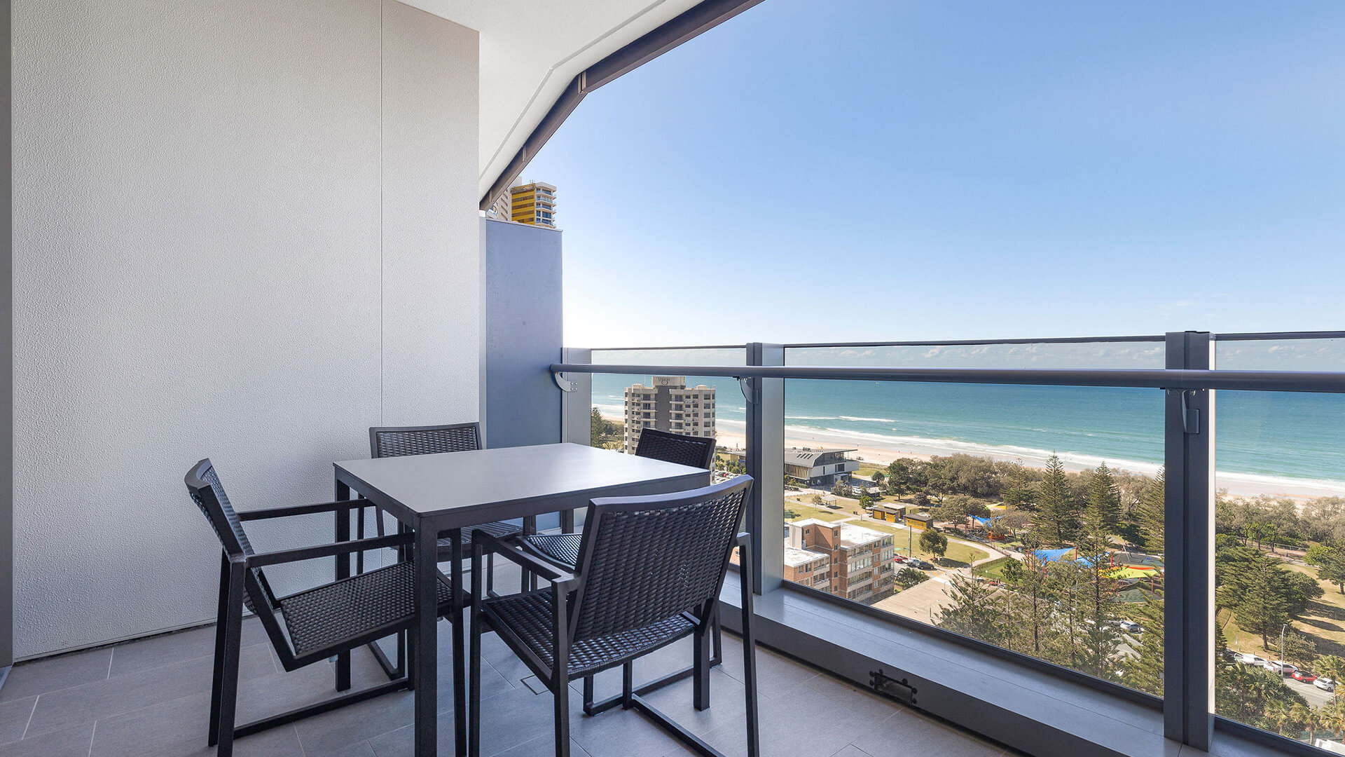 Private balcony with outdoor dining and ocean views in 1 Bedroom Ocean View Suite at ULTIQA Signature at Broadbeach.