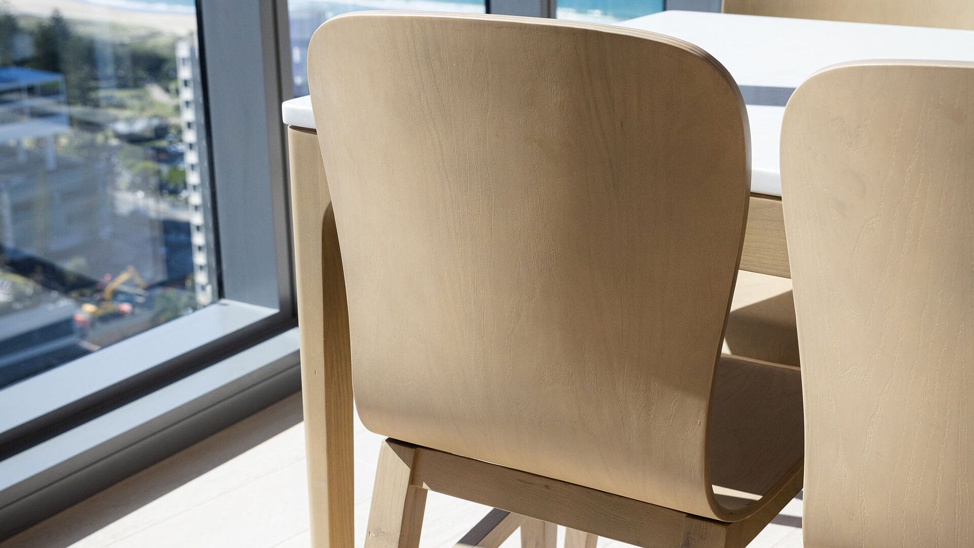 Dining chairs with ocean views in 2 Bedroom Ocean View Suite Premium at ULTIQA Signature at Broadbeach.