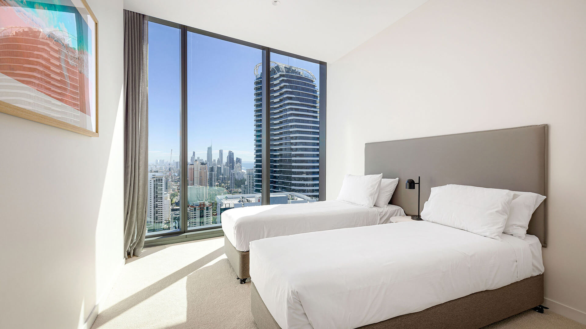 Twin bedroom in 3 Bedroom Ocean View Suite at ULTIQA Signature at Broadbeach with city views.
